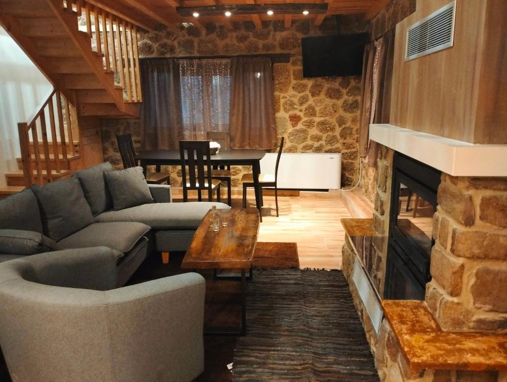 a living room with a couch and a fireplace at Erofili in Kato Trikala Korinthias