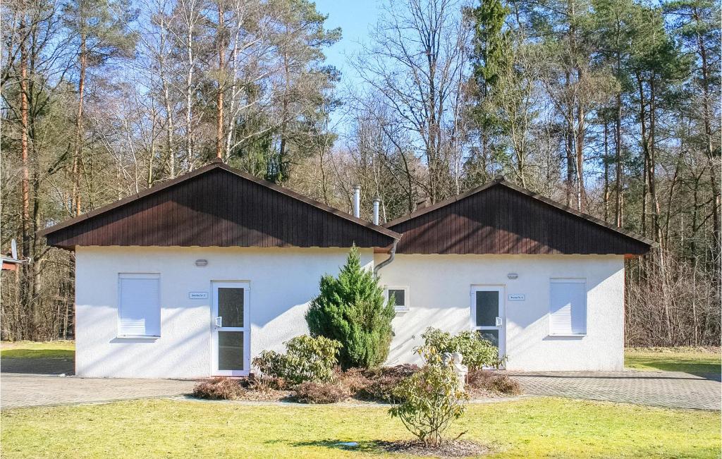 a white house with a black roof at Beautiful Home In Faberg-heidesee With Wifi in Oberohe