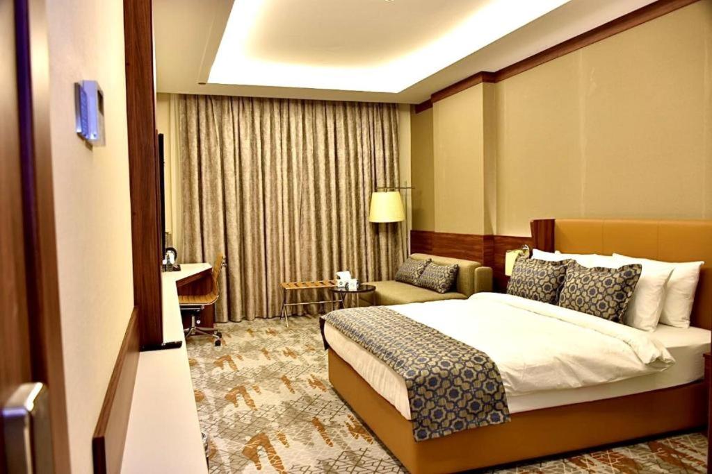 Postel nebo postele na pokoji v ubytování فندق رويال فيستا Royal Vista Hotel