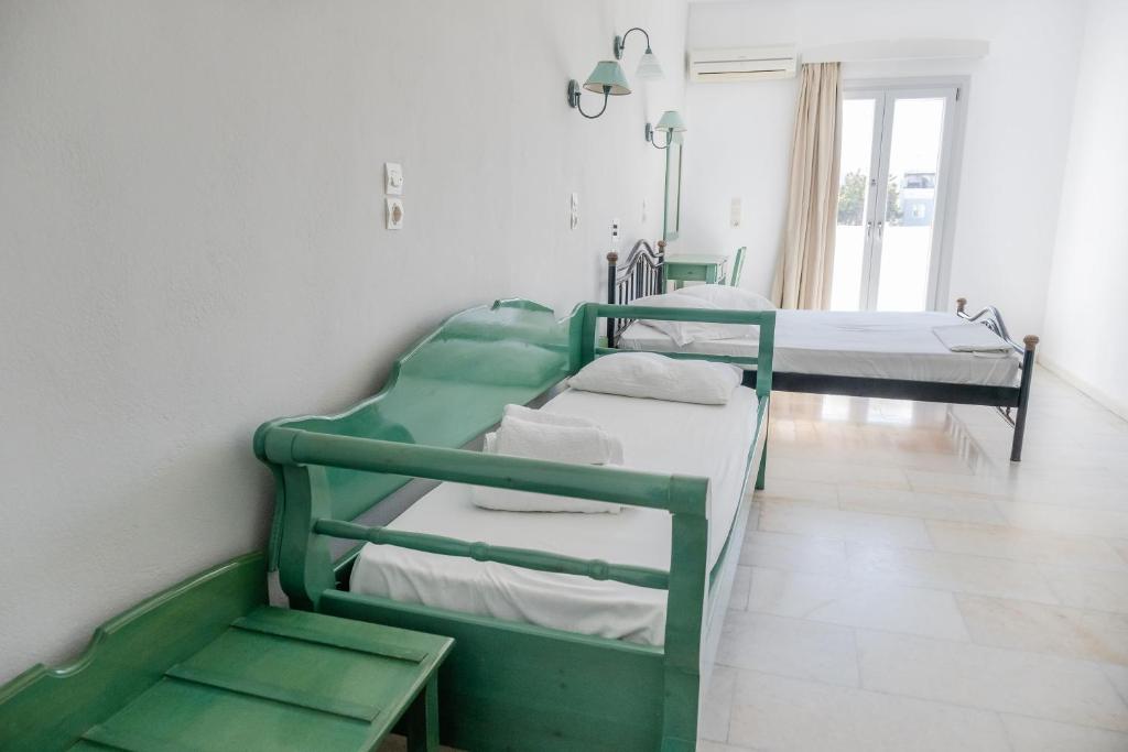 a hospital room with three bunk beds in it at Korali Garden in Naxos Chora