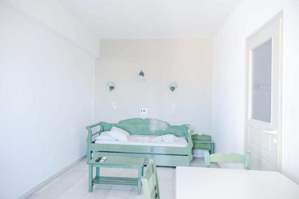 a bedroom with a bed and a table at Korali Garden in Naxos Chora