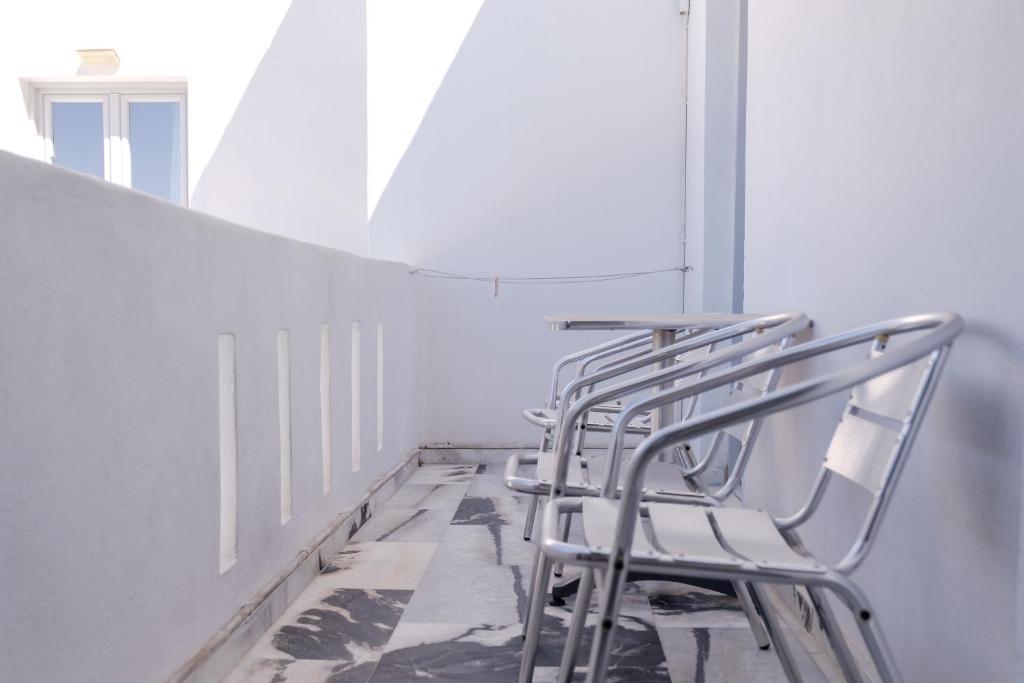 a row of metal chairs sitting in a room at Korali Garden in Naxos Chora