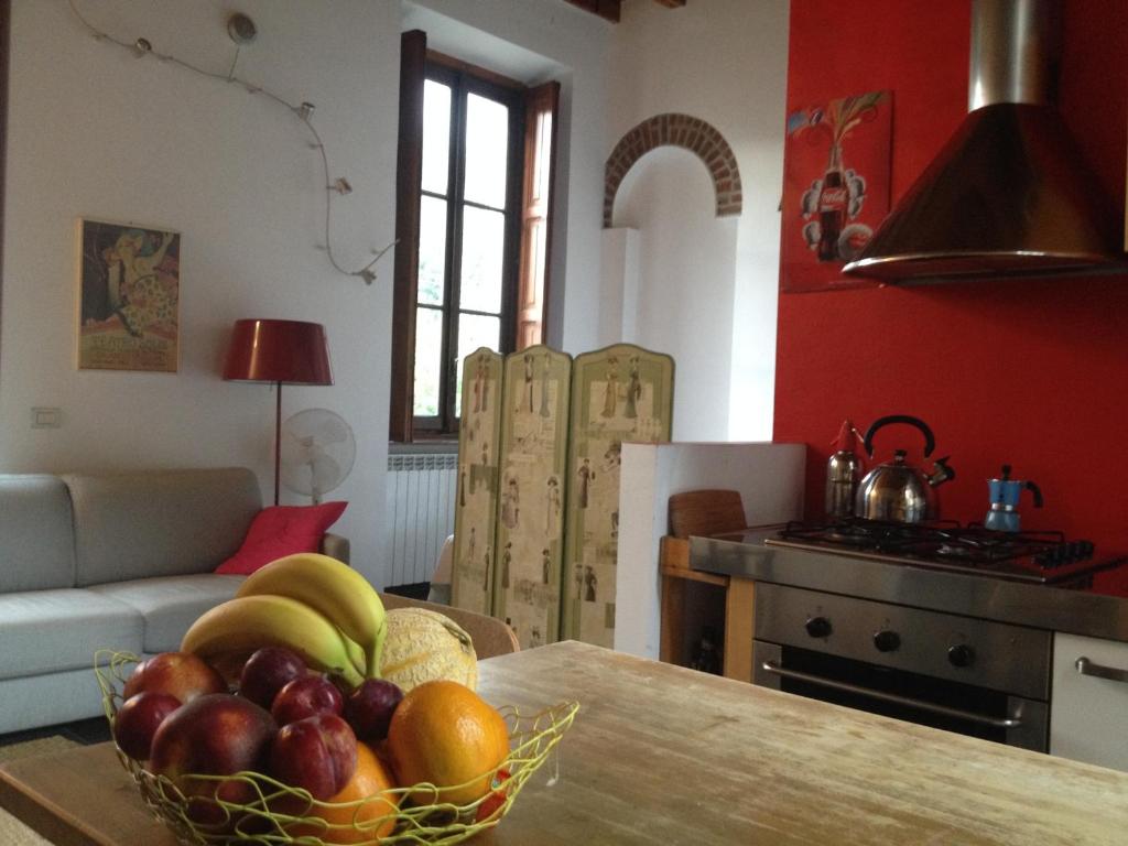 a kitchen with a bowl of fruit on a table at Lovelyloft Navigli - Gelsomino in Milan