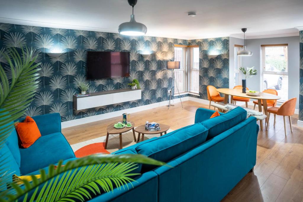 a living room with a blue couch and a table at All Saints House in Worcester