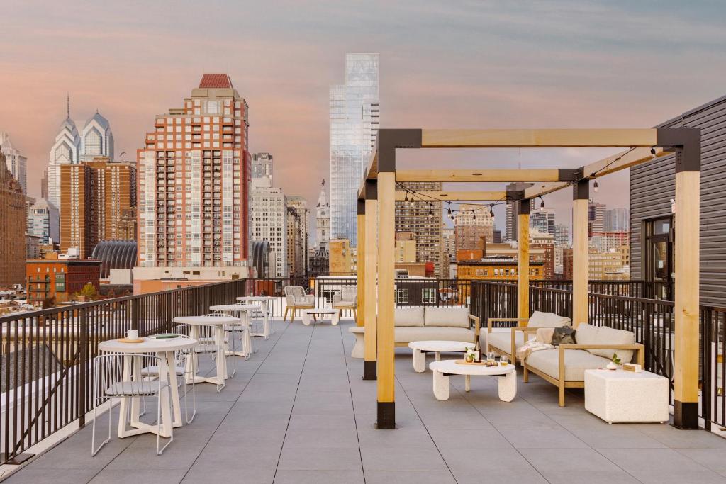 a balcony with tables and chairs and a city skyline at Sonder Ovation in Philadelphia