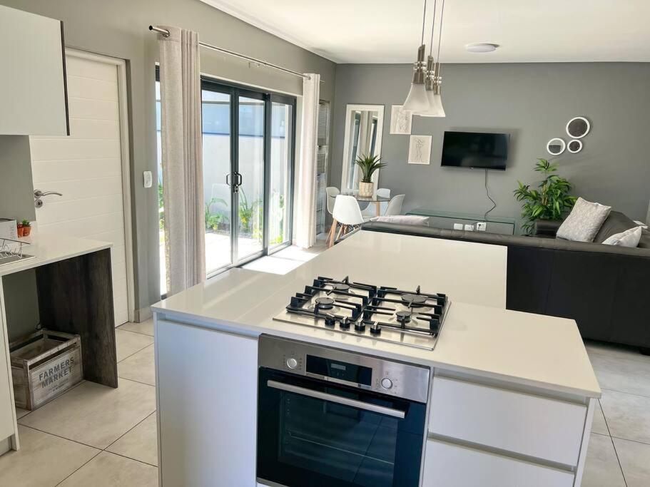 a kitchen with a stove top oven in a kitchen at Langebaan Holiday Home in Langebaan