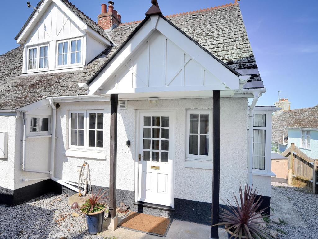 a white cottage with a white door at Waverley in Lyme Regis