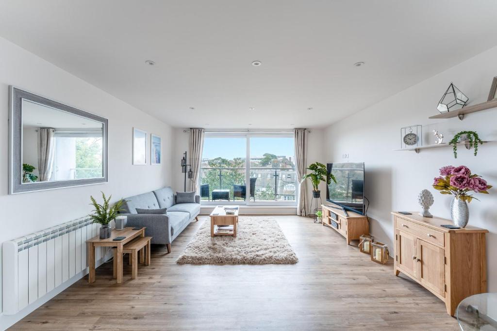 a living room with a couch and a tv at Azure in Bournemouth