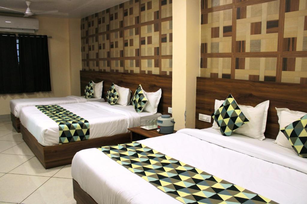 a hotel room with two beds in a room at Maruti Group of Hotels - Shri Naman in Nāthdwāra