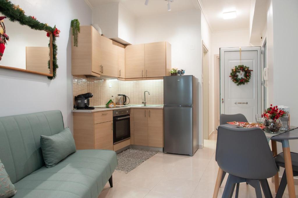 a kitchen with a couch and a refrigerator and a table at Centrale cozy home in Ioannina