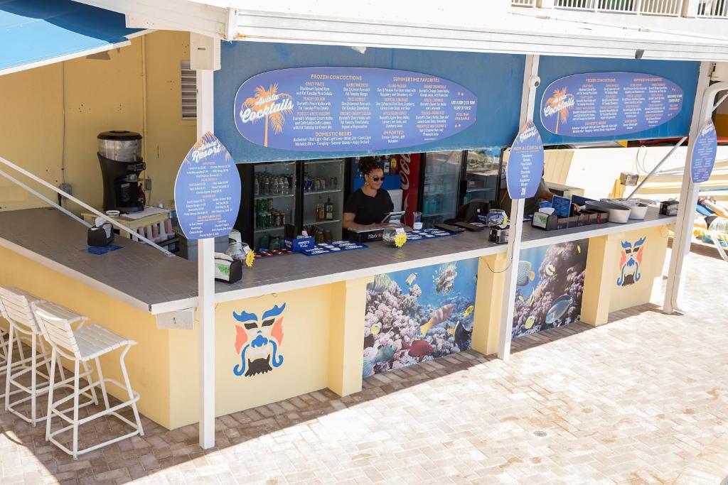 a food stand with a man sitting at a counter at Avista Resort in Myrtle Beach