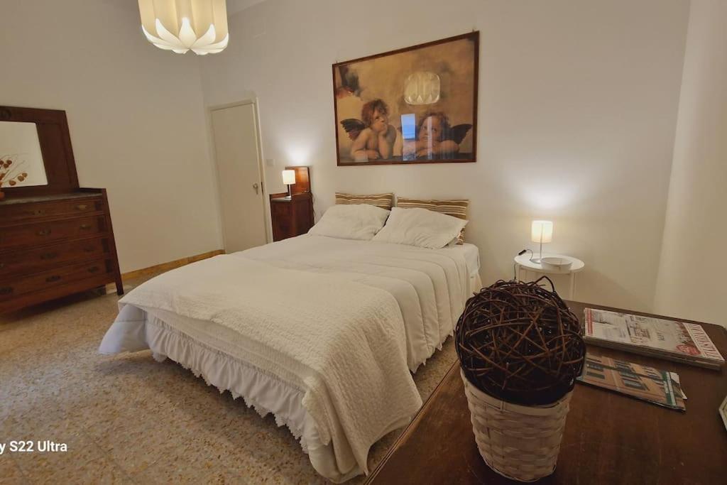 a bedroom with a large white bed and a table at Come a casa in Tognazza