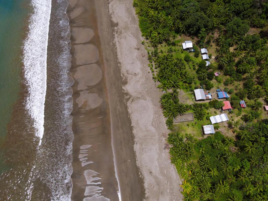 an aerial view of a beach with houses and the ocean at Mamá Orbe Family Eco Farm in El Valle