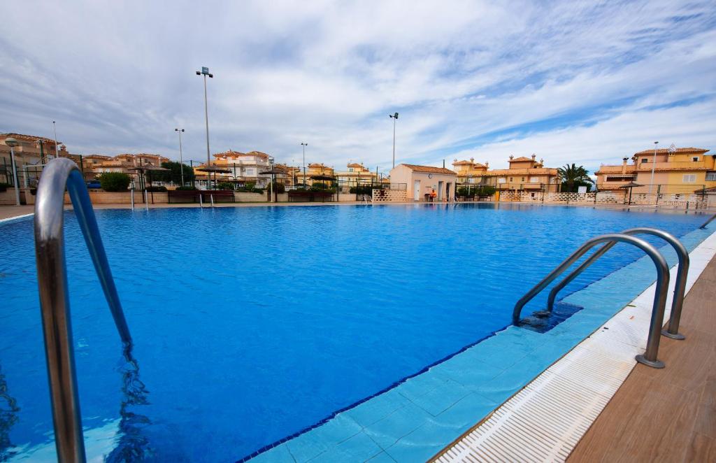 a large swimming pool with blue water at Holiday Beach Brissa Mar in Gran Alacant