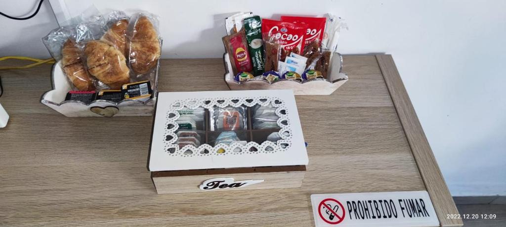 a table topped with a box of food and pastries at Málaga playa,centro ,bus y metro in Málaga