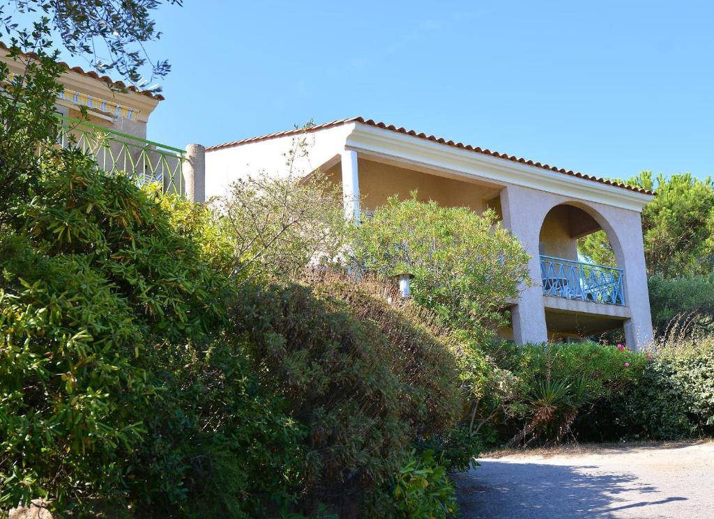 a house on a hill with bushes at Résidence Fior di Rena in Saint-Florent