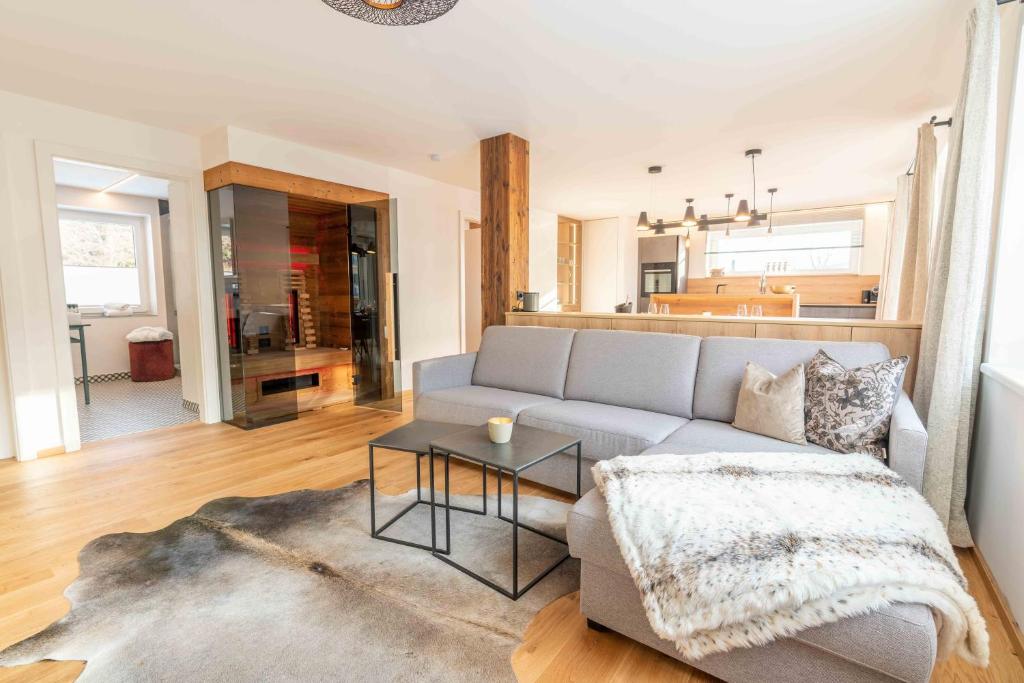 a living room with a couch and a table at Kaminzimmer Suite in Mauterndorf