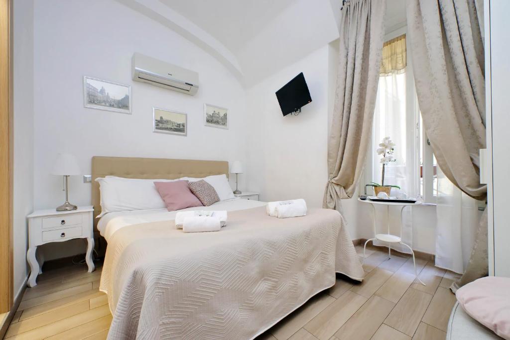 a bedroom with a bed with two towels on it at Dream City Rome in Rome