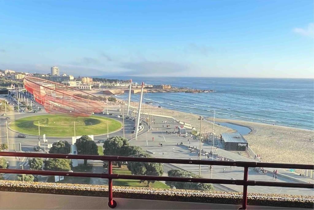 a view of a beach and the ocean from a balcony at MH by MGM - Premium Sea Views in Porto