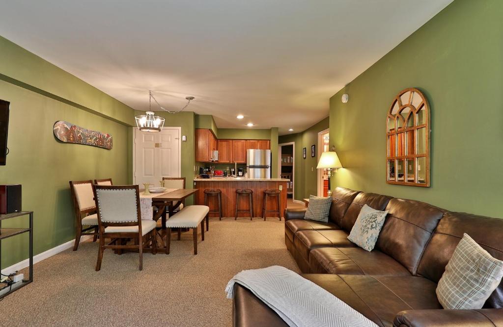 a living room with a couch and a table at The Pico Escape- 3BR 2BA Ski On Ski Off at Pico Mountain, Close to Killington, condo in Killington