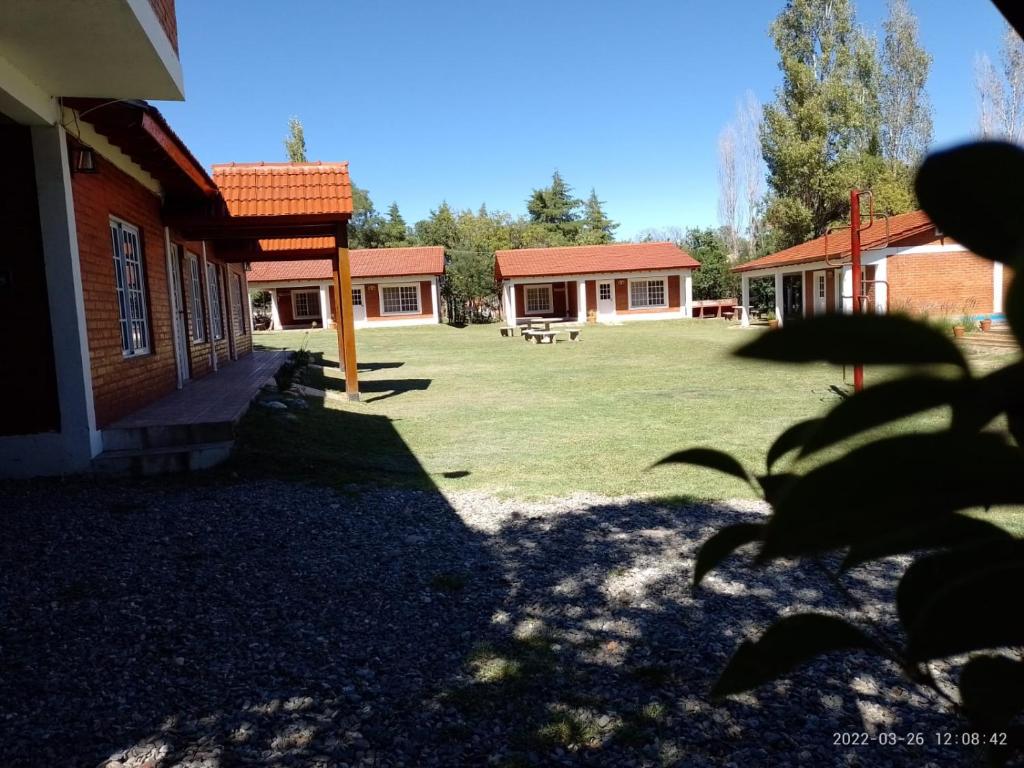 a large yard with a building and a house at Nuova Costa Cabañas in Los Molles