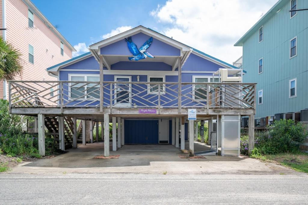 a blue house with a blue butterfly on the roof at Oceanfront Carolina Beach House - Dogs Allowed -Near Boardwalk in Carolina Beach