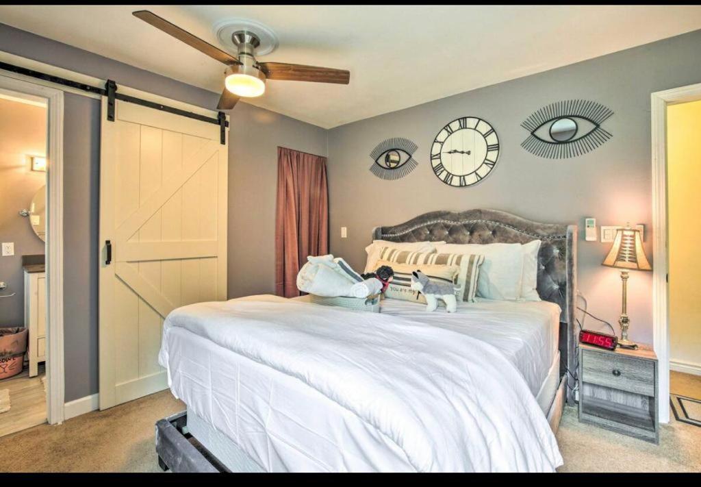 a bedroom with a large bed with a clock on the wall at Debdorkdave Hospitality Services in Poughkeepsie