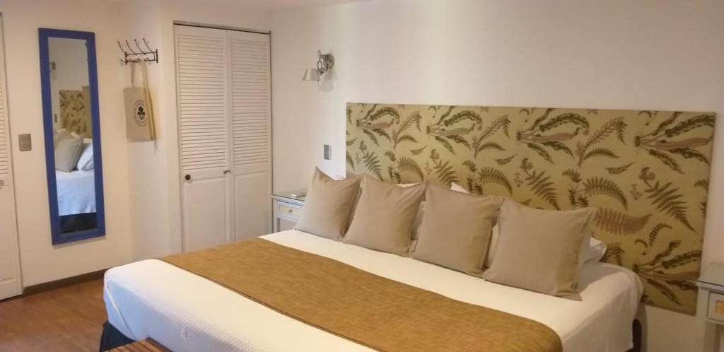 Postel nebo postele na pokoji v ubytování Hotel Boutique La Perouse