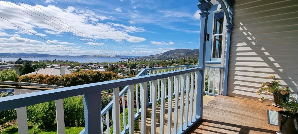 a balcony of a house with a view of the water at Hill House Hobart - Charming home, stunning views close to city in Hobart