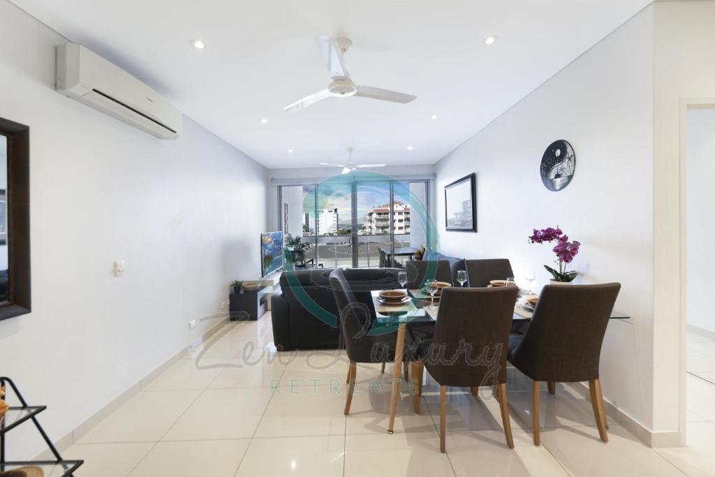a living room with a dining room table and chairs at ZEN CENTRAL Ambient 3BR Apt in the Heart of Darwin in Darwin