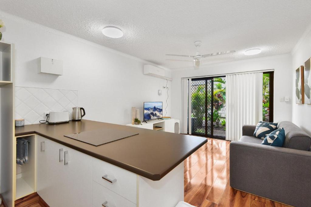 a kitchen and living room with a table and a couch at Allamanda Unit 22 in Long Jetty