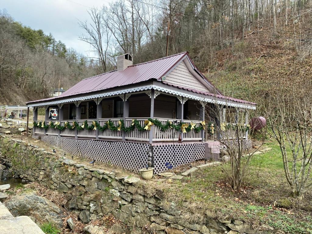 a house with a purple roof on a hill at Plum Crooked Poets Cottage - Walk to Town - Luxury King Bed - Near Asheville - Excellent Wi-Fi in Marshall