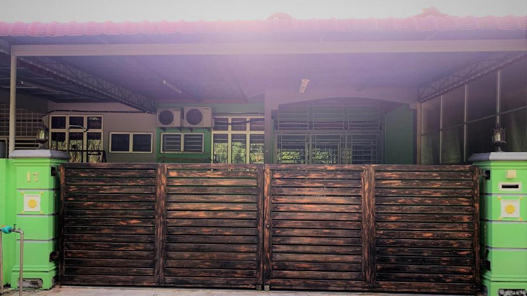 a wooden fence in front of a house at EQ Malay Modest Homestay Port Dickson in Port Dickson
