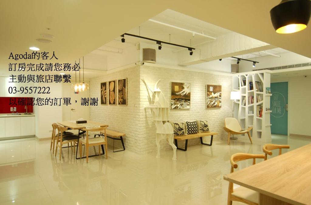 a dining room with tables and chairs in a room at Season 5 Inn in Luodong
