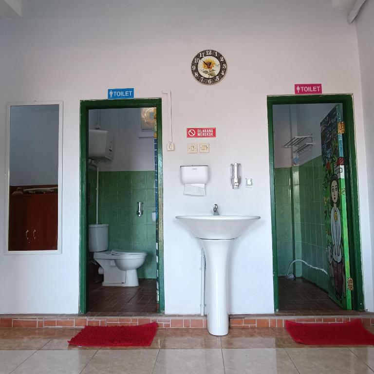 a bathroom with a sink and a toilet at BSH (Bu Sud's House) Yogyakarta in Yogyakarta