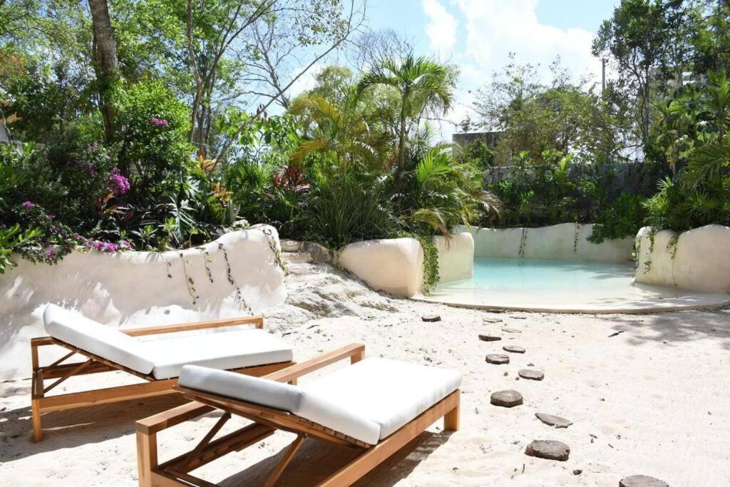 a patio with chairs and a swimming pool at iiK 501 beautiful and classy appartment in Tulum