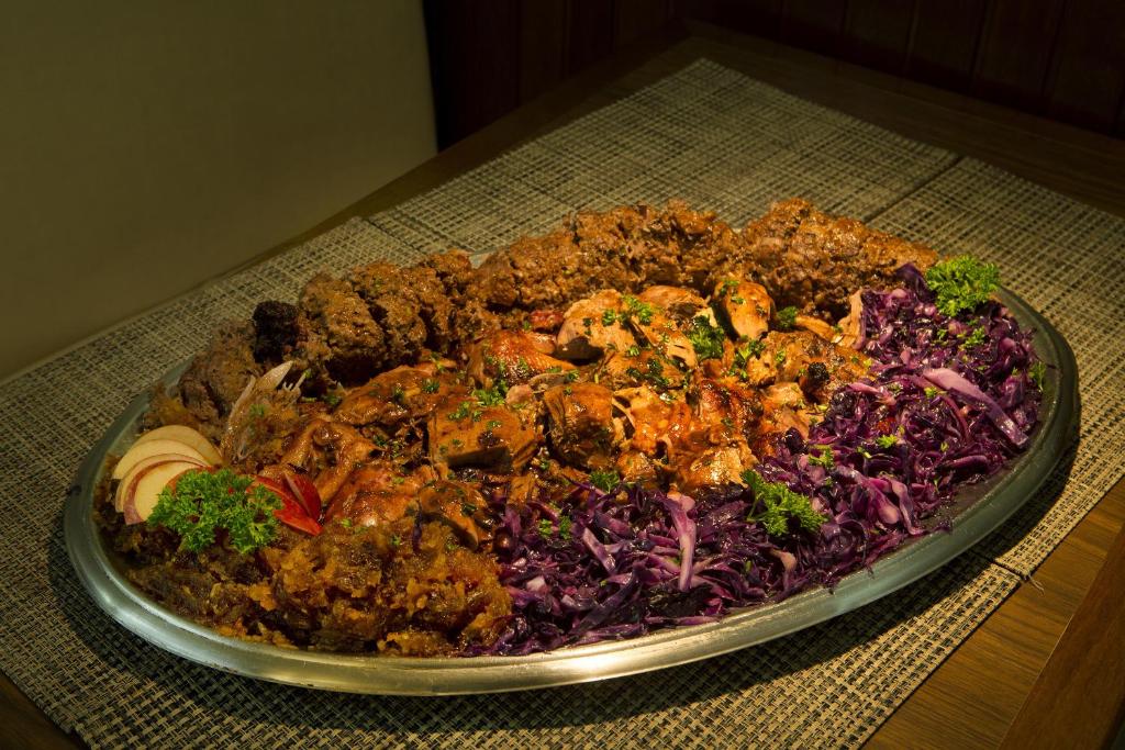 a plate of food sitting on top of a table at Hotel Raul's in Gaspar