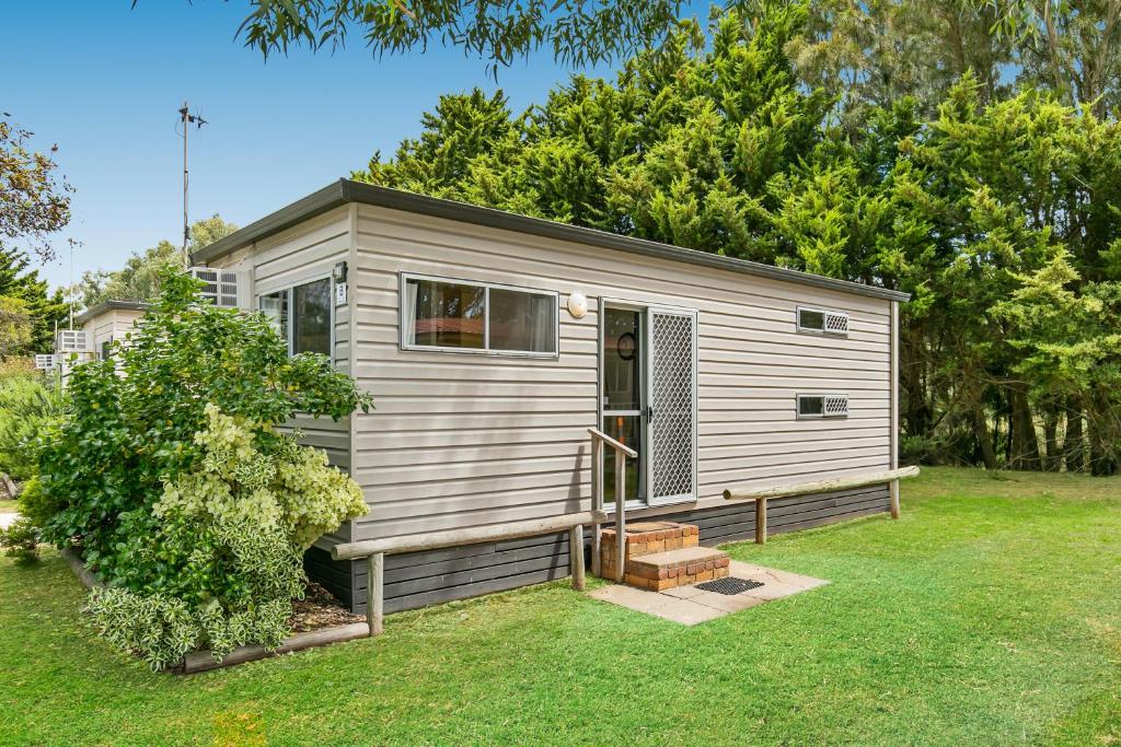 a tiny house in a yard with a tree at BIG4 Breeze Holiday Parks - Port Elliot in Port Elliot