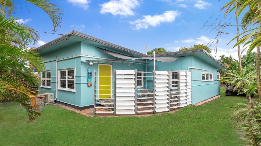 a blue house with a lawn in front of it at 92 Landsborough Parade Golden Beach in Golden Beach