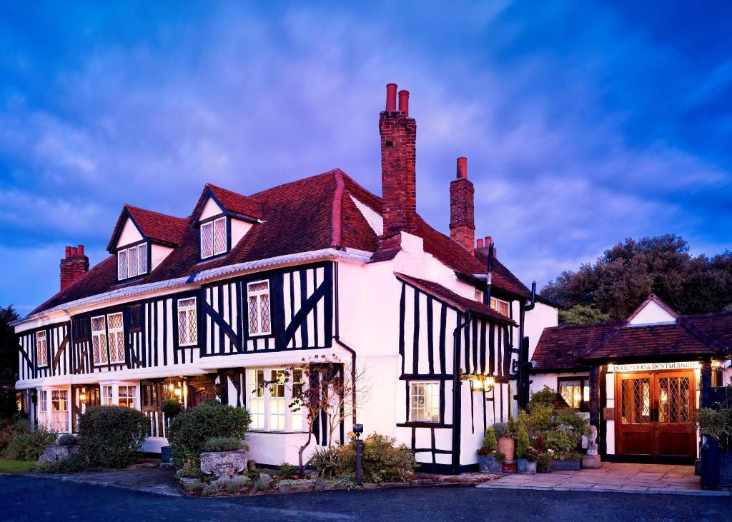 a large white house with black and white detailing at Marygreen Manor in Brentwood