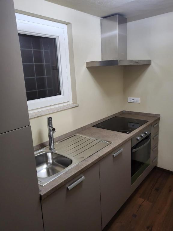 a small kitchen with a sink and a window at Incantevole monolocale in Perugia