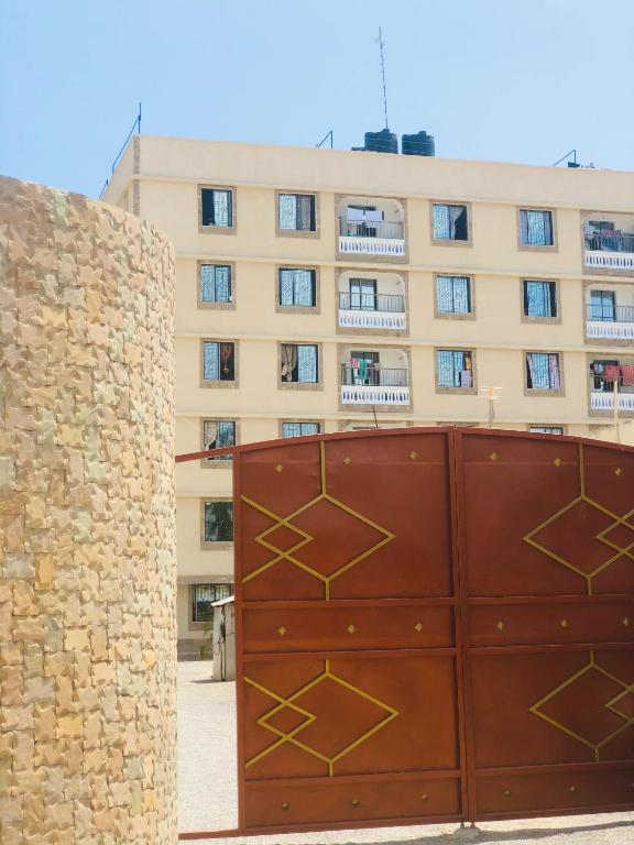 a brown gate in front of a building at Mtwapa Apartment in Mombasa