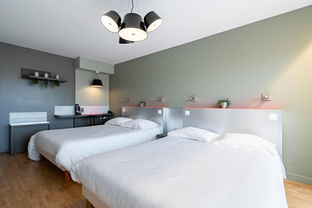 Postel nebo postele na pokoji v ubytování Hôtel Vulcain