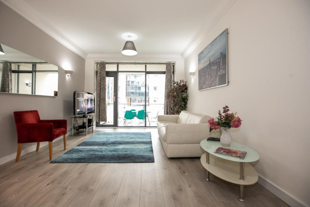 a living room with a couch and a table at IFSC Townhouse Apartments in Dublin