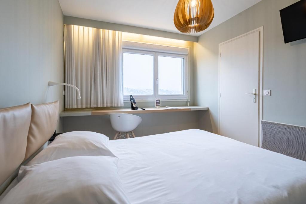 Postel nebo postele na pokoji v ubytování Hôtel Vulcain