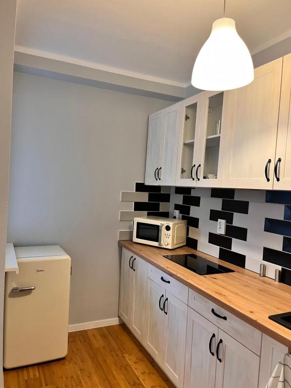 Kuchyňa alebo kuchynka v ubytovaní Apartament z widokiem na Spodek