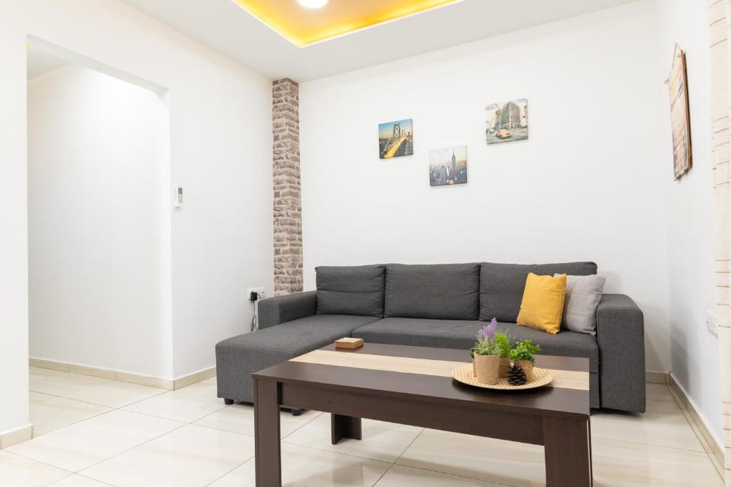 a living room with a couch and a table at F & B Collection - 2BR Fast Wi-Fi Penthouse in Thessaloniki