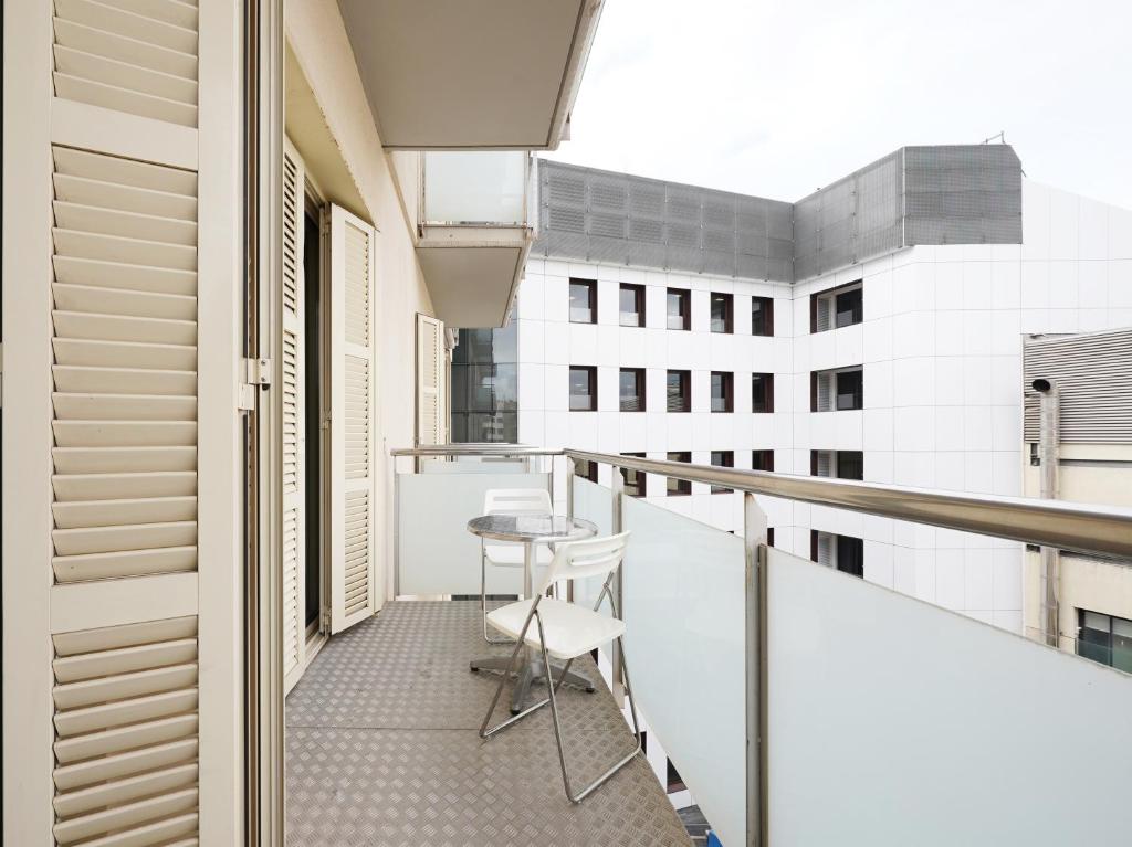 a balcony with a table and chairs on it at numa l Lumino Apartments in Barcelona