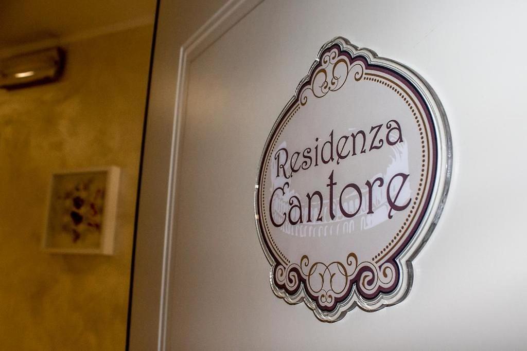 a mirror on a wall with a sign on it at Residenza Cantore in Verona