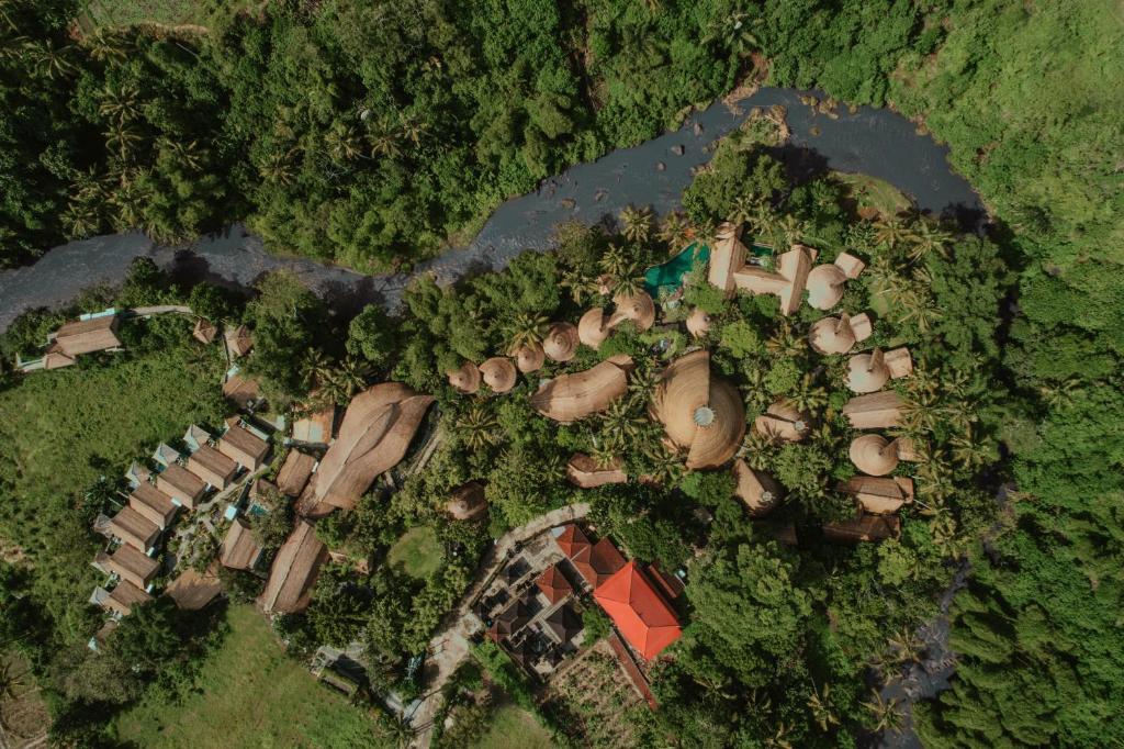 an overhead view of a mansion with trees and a yard at Fivelements Retreat Bali in Ubud